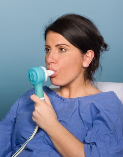 A patient inhaling gas and air through an Entonox mouthpiece